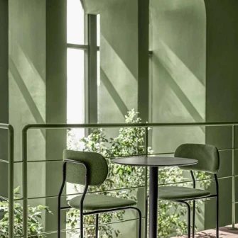 Geometric view looking towards the green arched windows, focusing on shadows and reflections