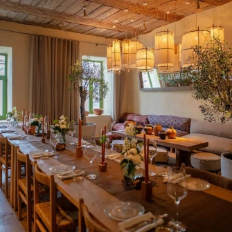 Seliam in Kyiv - dining room with long banquet table, olive trees and lanterns