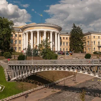 October Palace in Kyiv - view of the historic building behind a metal pedestrian bridge
