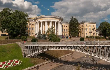 October Palace in Kyiv - view of the historic building behind a metal pedestrian bridge
