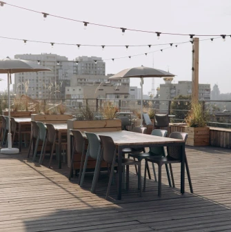 Kooperativ - relaxed outdoor dining area with wooden furniture