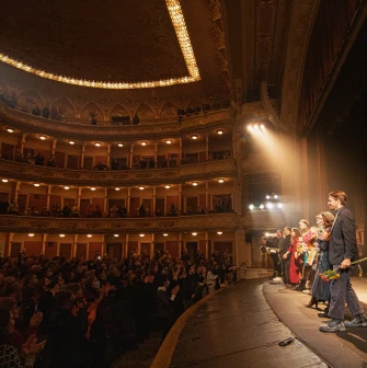 Teatr Franka in Kyiv - warmly lit stage scene with actors lining up after a performance