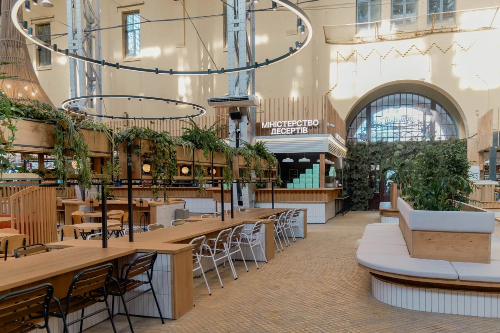 Wooden tables and seating in Bessarabskyi Market food court in Kyiv