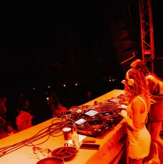 Kureni - female DJs performing on stage under red lighting