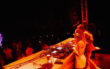 Kureni - female DJs performing on stage under red lighting