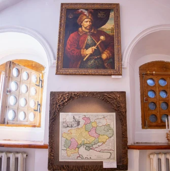 Muzei Hetmanstva in Kyiv - thick white walls with arched window niches displaying a historic portrait of a Hetman and an ancient map of Ukraine
