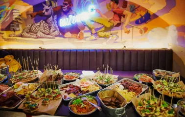Punkraft - overhead view of a hearty appetizer plate and a food menu