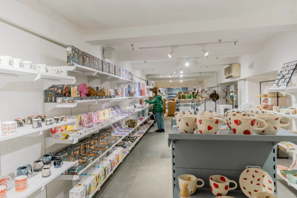 Ceramic cups and home decor on shelves at Vsi Svoi store in Kyiv