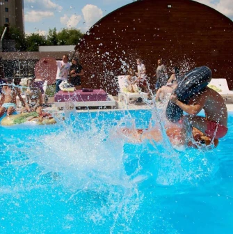 Water splashes and vacationers in the pool at Sungrilla Beach club