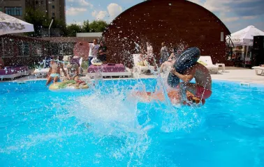 Water splashes and vacationers in the pool at Sungrilla Beach club