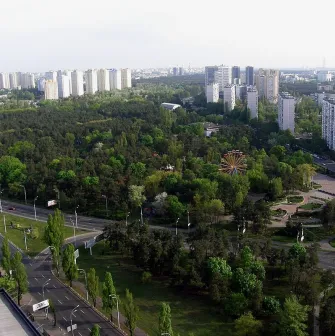 Peremoha Park in Kyiv - aerial view of the green park landscape featuring a Ferris wheel and residential buildings