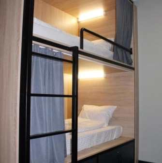 Bunk beds with lighting and curtains at Kyiv Hostel in Kyiv