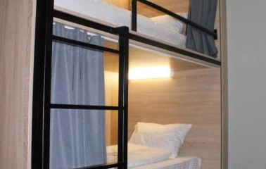 Bunk beds with lighting and curtains at Kyiv Hostel in Kyiv