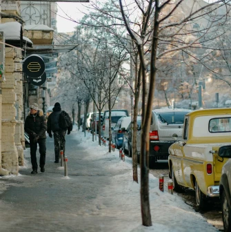 Round OG Burger sign on a historic yellow facade on Reitarska in Kyiv