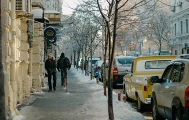 Round OG Burger sign on a historic yellow facade on Reitarska in Kyiv