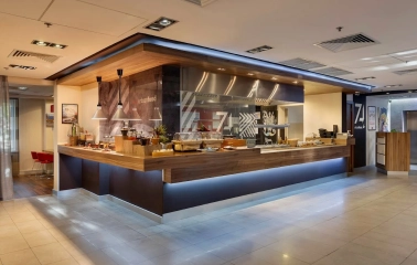 Ibis Kyiv City Center in Kyiv - buffet line with wooden counter and food stations
