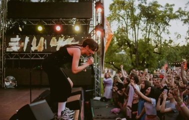 Vyava in Kyiv - singer in black leaning into a microphone in front of a crowd