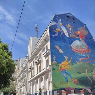 Time of Changes in Kyiv - building facade with a mural