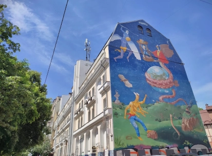 Time of Changes in Kyiv - building facade with a mural