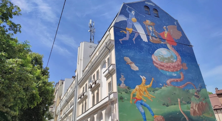 Time of Changes in Kyiv - building facade with a mural