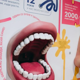 A large model of a human mouth on an information panel at the Science Museum in Kyiv