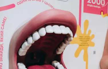 A large model of a human mouth on an information panel at the Science Museum in Kyiv