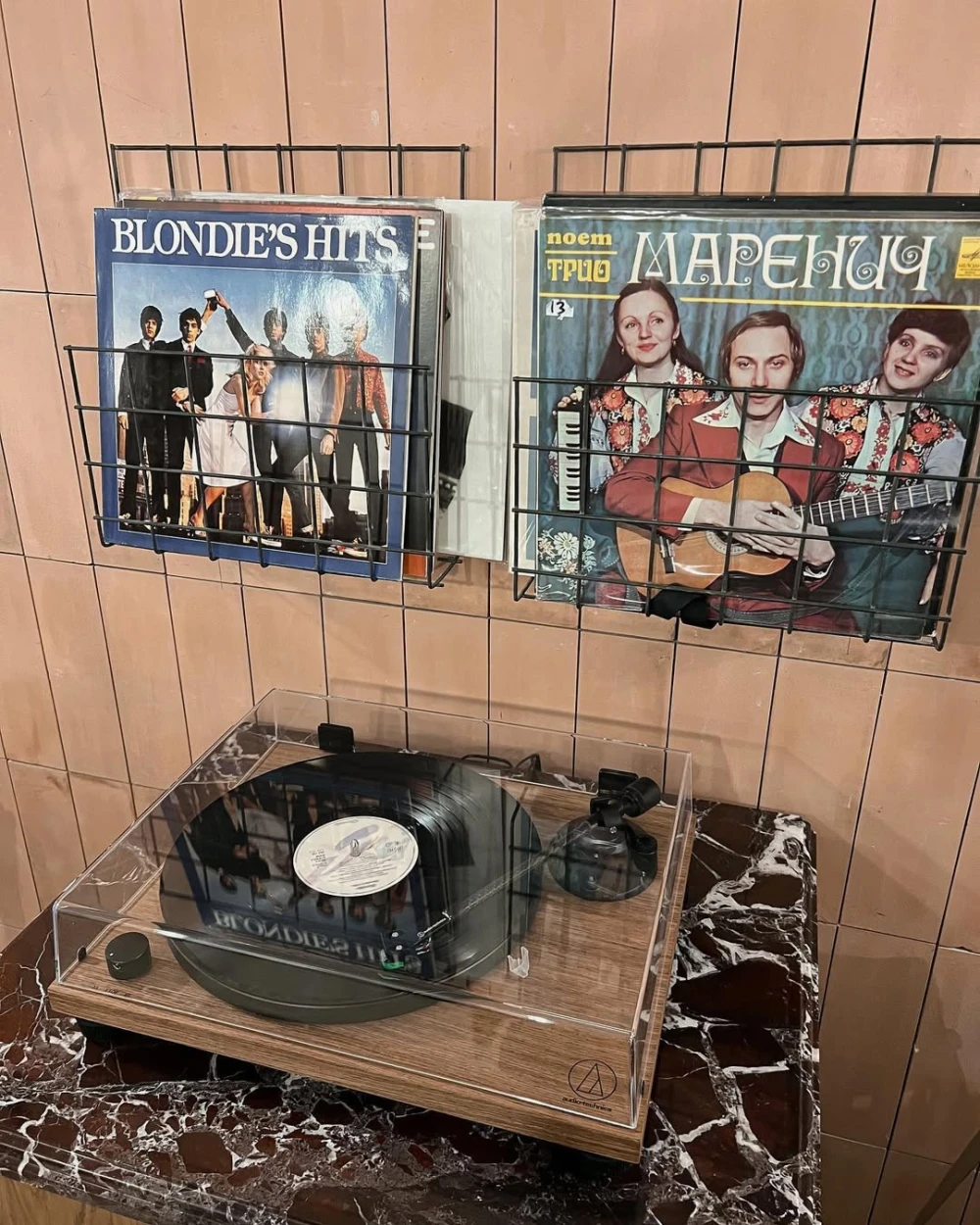 Spelta – record player and vinyl albums on wall adding vintage café vibe