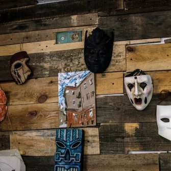 Decorative masks on a wooden wall at Vagabond Cafe in Podil, Kyiv