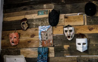 Decorative masks on a wooden wall at Vagabond Cafe in Podil, Kyiv