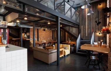 True Burger Bar - industrial style interior with exposed brick and varied comfortable seating