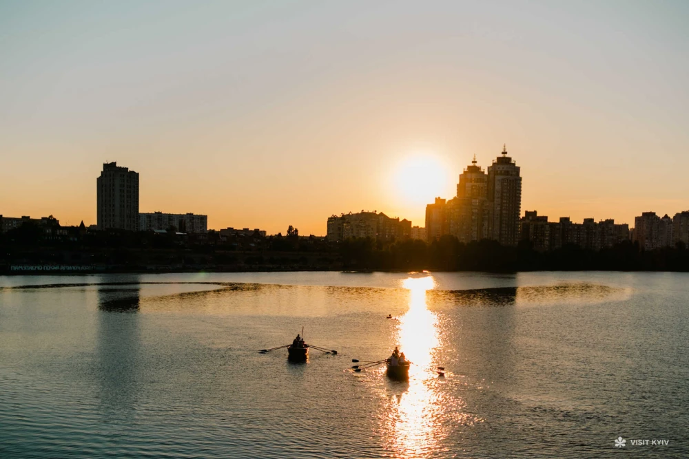 People canoeing at sunset on the Dnipro River