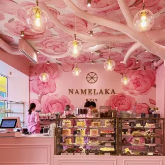 A showcase with cakes in the pink Namelaka coffee shop in Kyiv