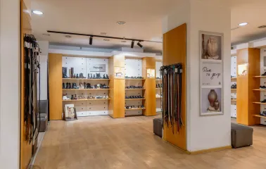 Footwear display with boots and leather shoes on shelves at Vsi Svoi store in Kyiv