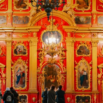 St. Andrew's Church in Kyiv - close-up of red and gold iconostasis with chandelier
