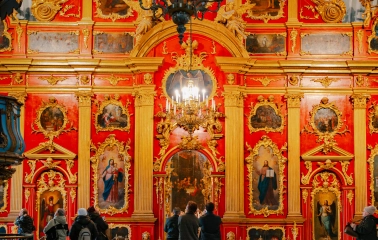 St. Andrew's Church in Kyiv - close-up of red and gold iconostasis with chandelier
