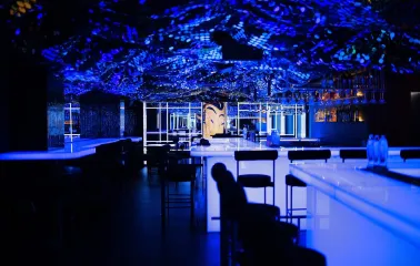 Sansara - sleek modern bar counter featuring decorative lighting and various bottles