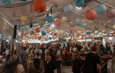 Art-zavod Platforma in Kyiv - spacious food court hall filled with people under a ceiling covered in hundreds of colorful paper lanterns