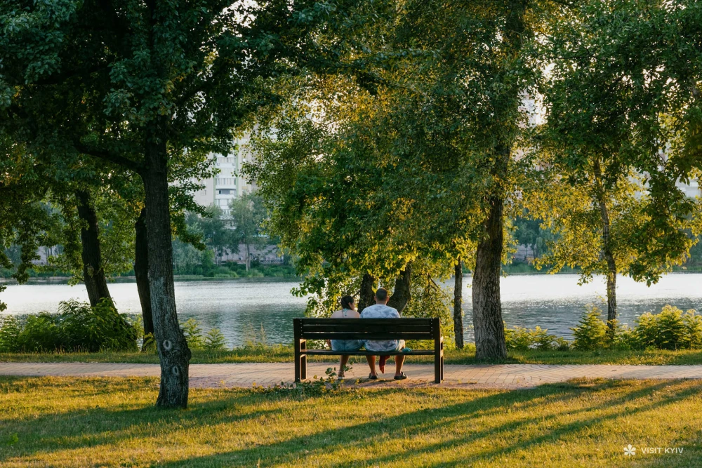 A couple sits on the Obolon embankment