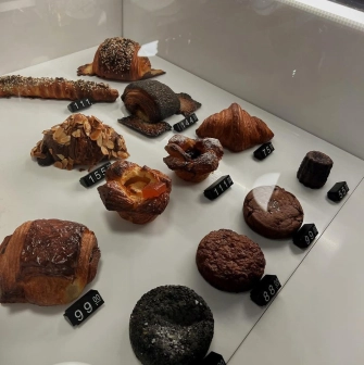 Spelta - counter display of various fresh baked goods including bread and pastries