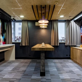 Ibis Railway Station in Kyiv - Break room with wooden table and coffee machine