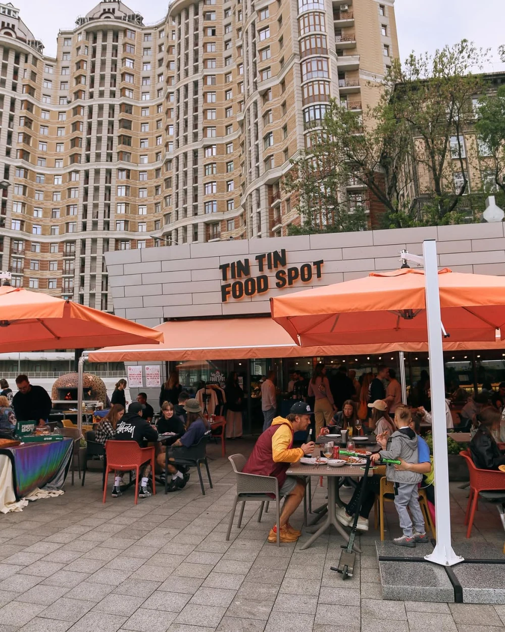 Summer terrace of Tin Tin Food Spot with orange umbrellas