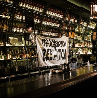 BarmanDictat - bar counter lined with rows of drinks