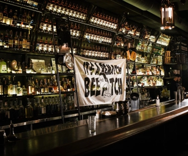 BarmanDictat - bar counter lined with rows of drinks
