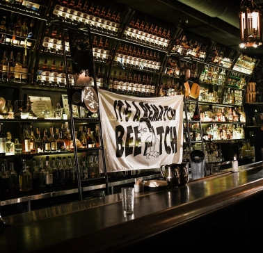 BarmanDictat - bar counter lined with rows of drinks
