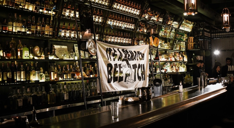BarmanDictat - bar counter lined with rows of drinks
