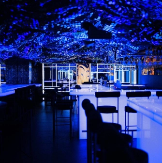 Sansara - sleek modern bar counter featuring decorative lighting and various bottles