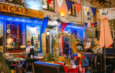 Très Français - outdoor terrace with chef, musician and decorated facade
