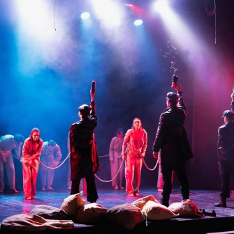 Mala Opera in Kyiv - dramatic theatrical performance with actors raising props amidst a haze of bubbles