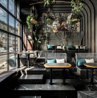 NAM - dining area featuring elegant dark furniture and unique light fixtures