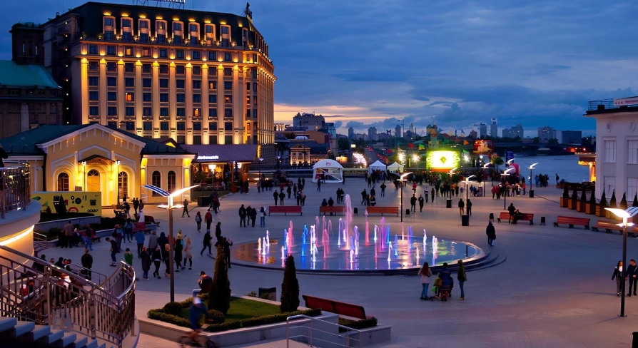 Poshtova Square in Kyiv - evening view with illuminated fountains and walking people